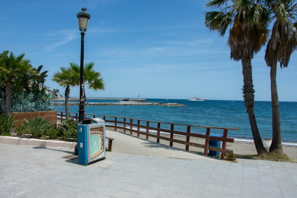 Paved coastal Paseo Maritimo promenade connecting central Marbella to Puerto Banus