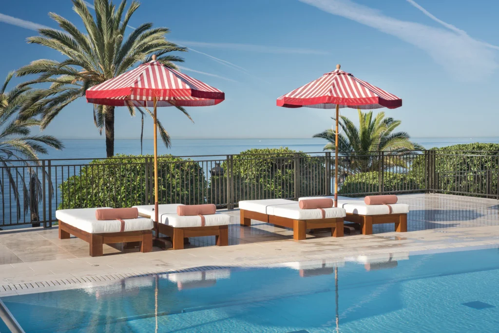 Family-friendly 5-star Hotel El Fuerte Marbella poolside terrace with sea views and sun loungers