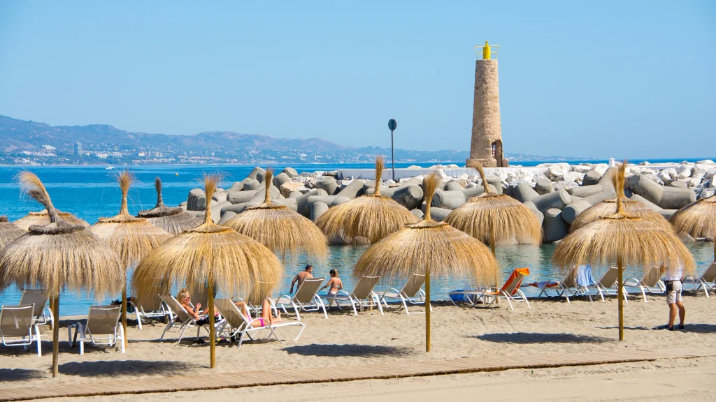 Playa de Puerto Banus sheltered bay with sun loungers and view of La Concha