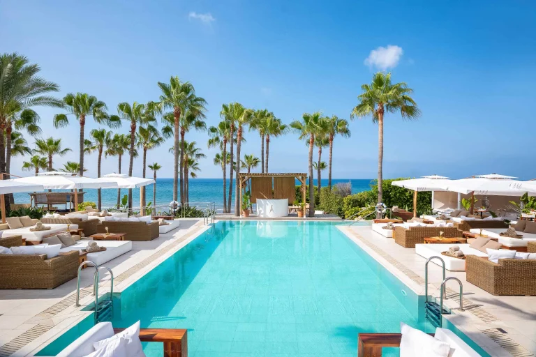 Nikki Beach Marbella luxury pool and daybeds overlooking the Mediterranean Sea