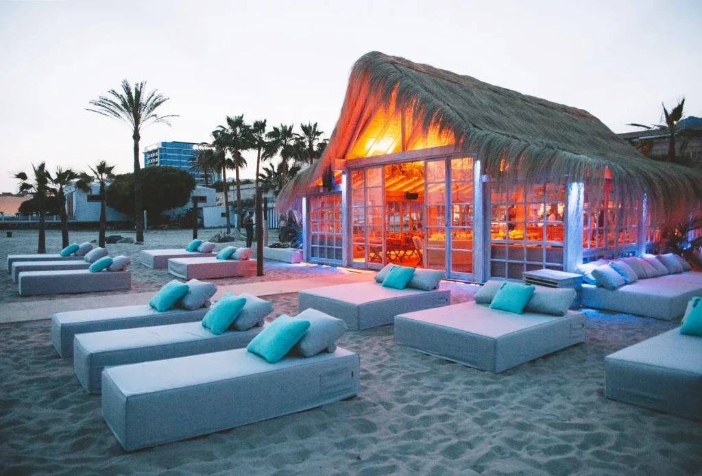 Playa Padre beach club boho-chic daybeds and thatched palapa on Playa del Cable Marbella