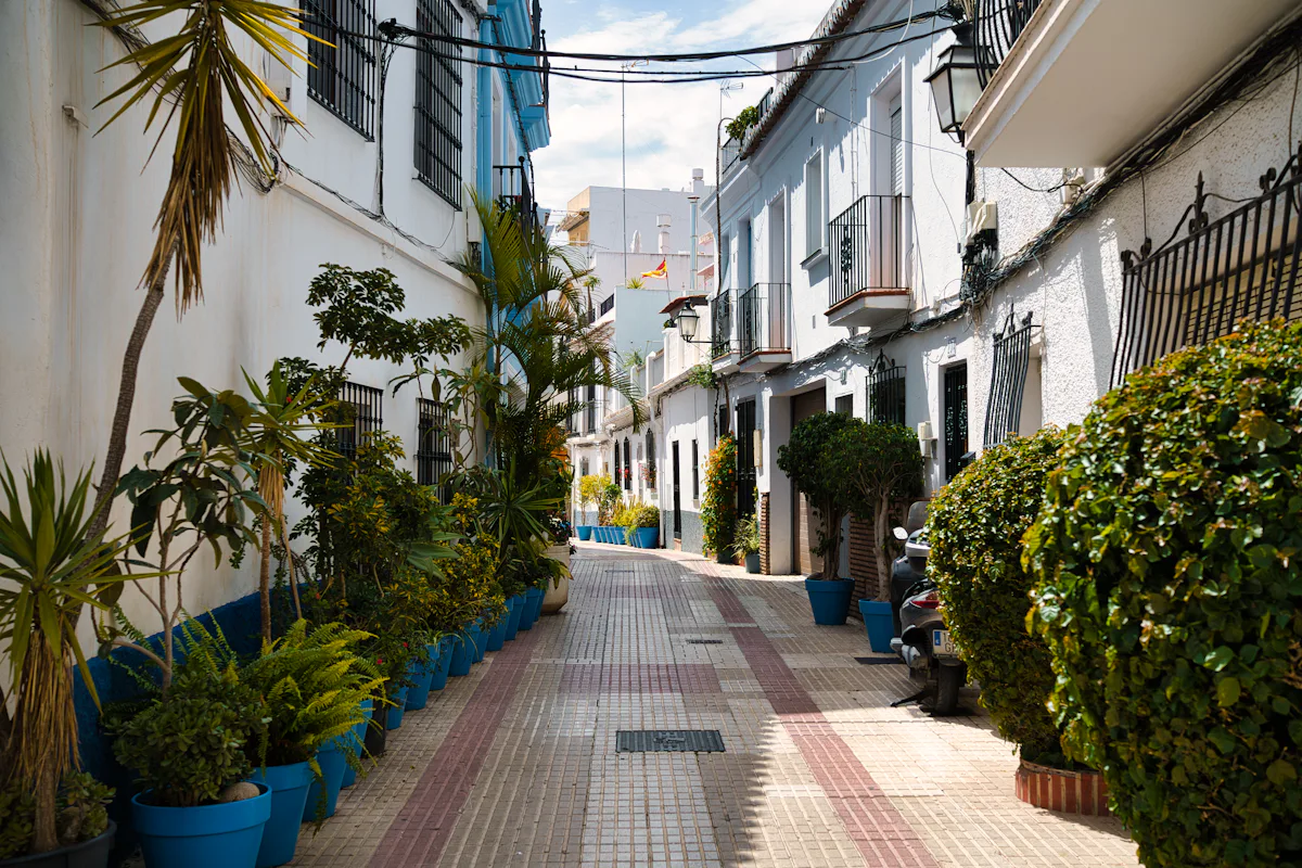 Narrow Marbella Old Town street lined with potted plants