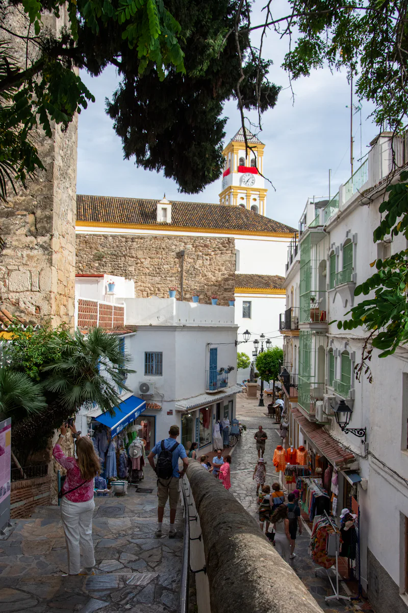 People walking along a narrow street in Marbella Old Town