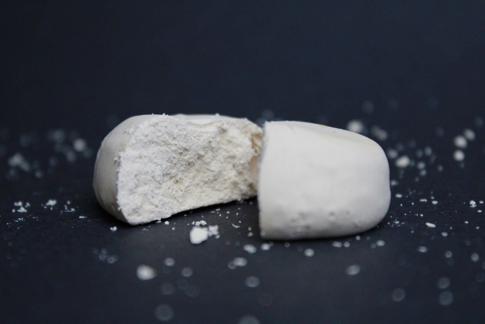 A polvorón broken in half, a traditional Spanish Christmas sweet
